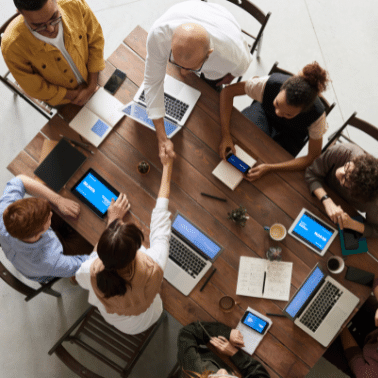 Birds eye view of people gathered around a table talking