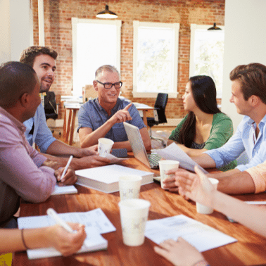 One older white male leads discussion with three younger males and one females of various ethnicities